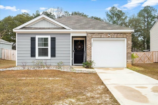 view of front of property featuring a garage and a front yard