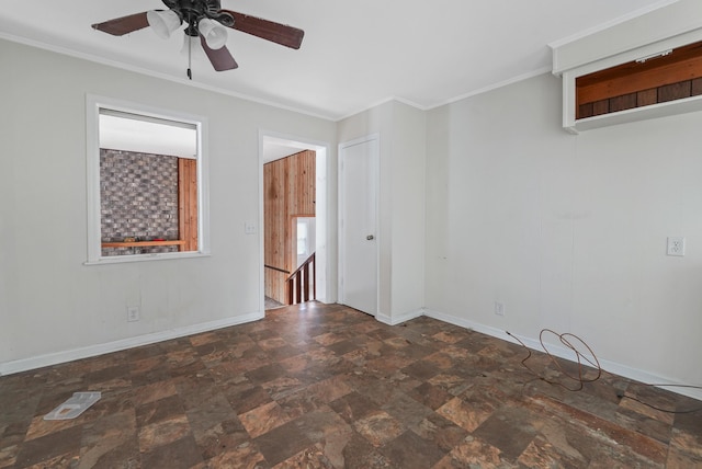 unfurnished room featuring ceiling fan and ornamental molding