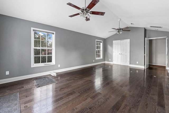 unfurnished living room featuring dark hardwood / wood-style floors and vaulted ceiling