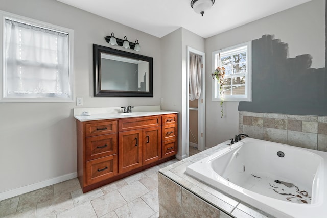 bathroom featuring vanity and tiled bath