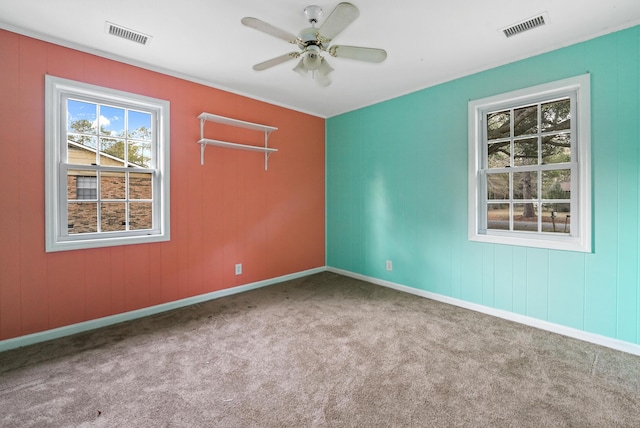 carpeted empty room featuring ceiling fan