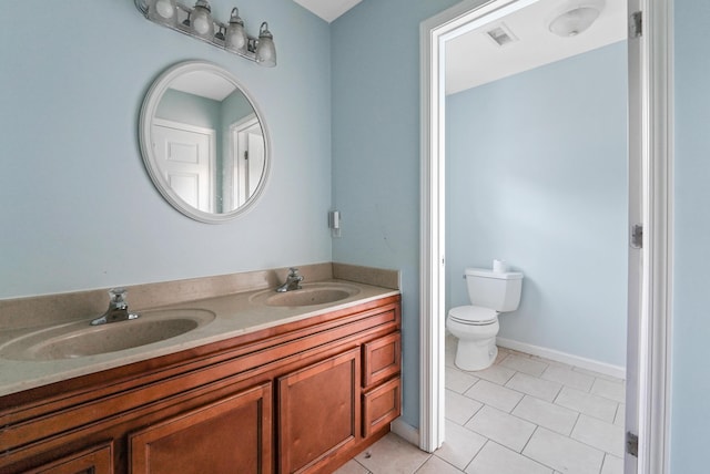 bathroom featuring tile patterned floors, vanity, and toilet