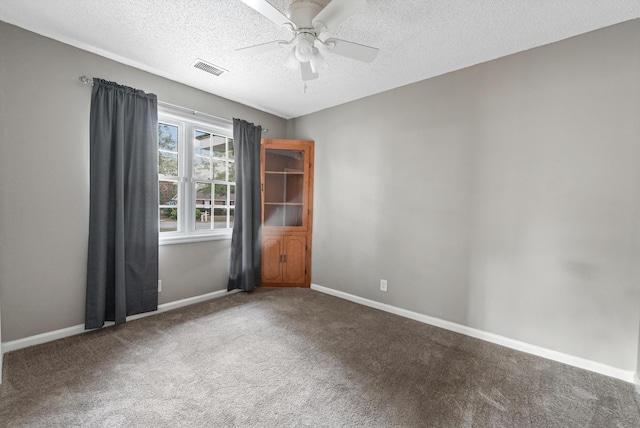 carpeted empty room with a textured ceiling and ceiling fan