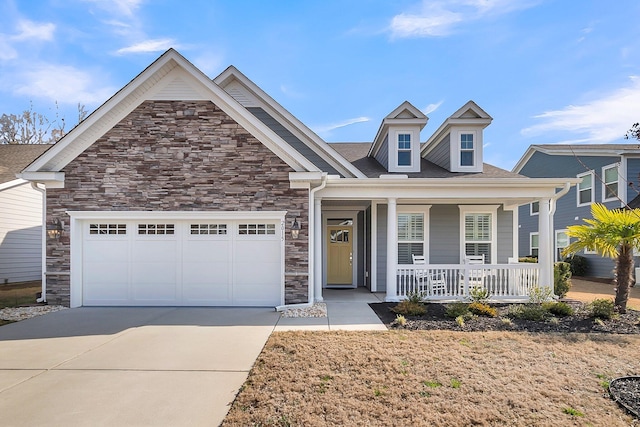 view of front of home featuring a porch and a garage