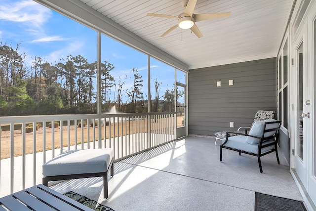 sunroom featuring ceiling fan