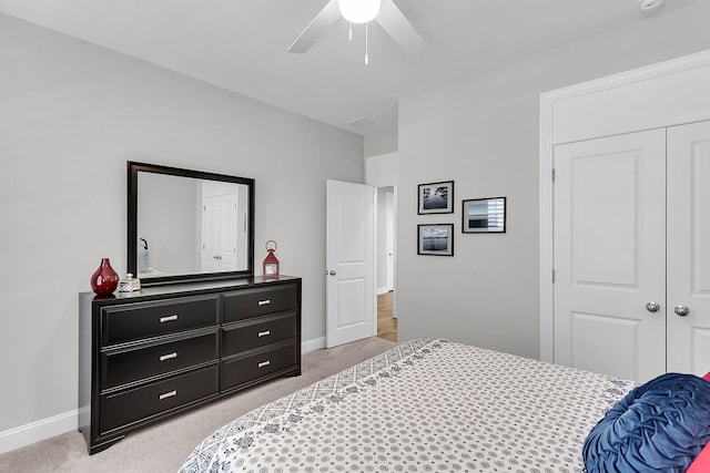 carpeted bedroom featuring a closet and ceiling fan