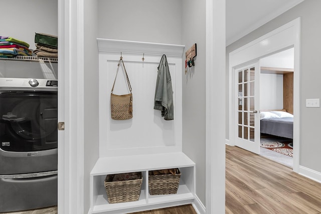 mudroom with wood-type flooring, washer / dryer, and french doors