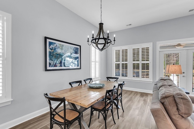 dining room featuring wood-type flooring and a chandelier