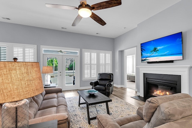 living room with french doors, ceiling fan, and hardwood / wood-style floors