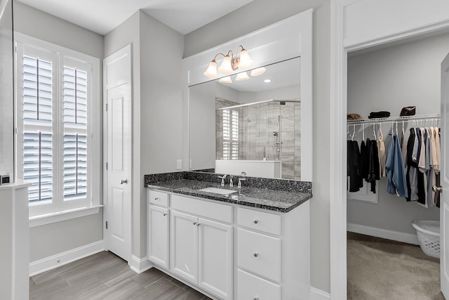 bathroom with walk in shower and vanity