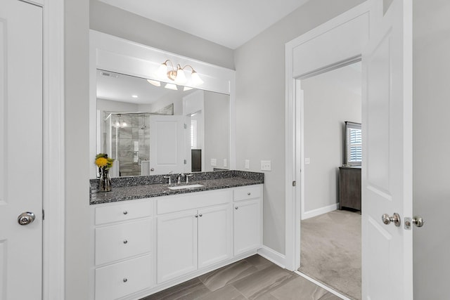 bathroom featuring vanity and an enclosed shower