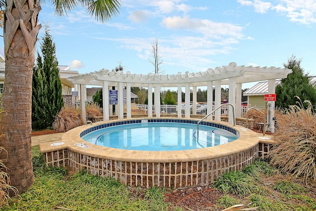 view of swimming pool with a hot tub and a pergola