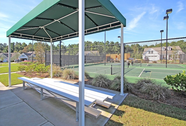 view of home's community with tennis court