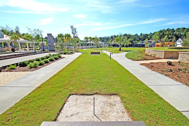 view of property's community featuring a yard