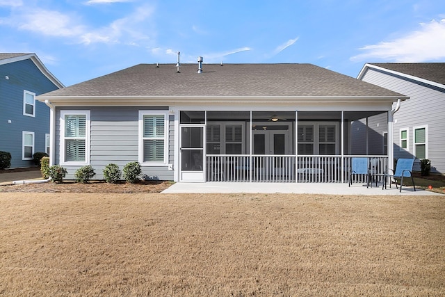 back of house featuring a patio, a sunroom, and a lawn