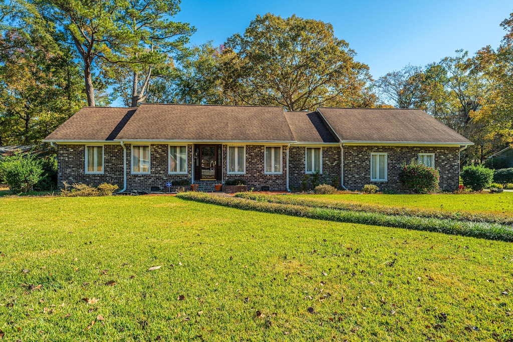 ranch-style home with a front lawn