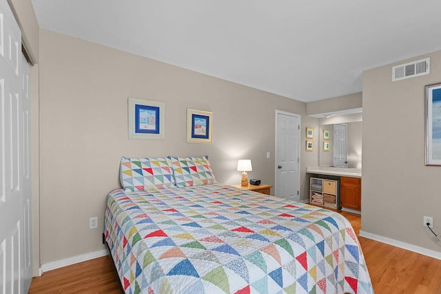 1627 Live Oak Park, Seabrook Island, SC 29455 - bedroom with wood finished floors, baseboards, and ensuite bath