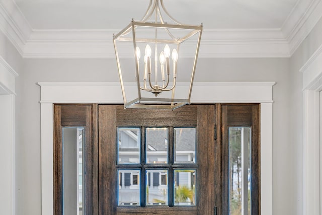 interior details with ornamental molding and a notable chandelier