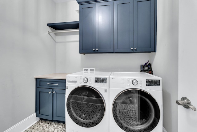 laundry area with washing machine and dryer, light tile patterned floors, and cabinets