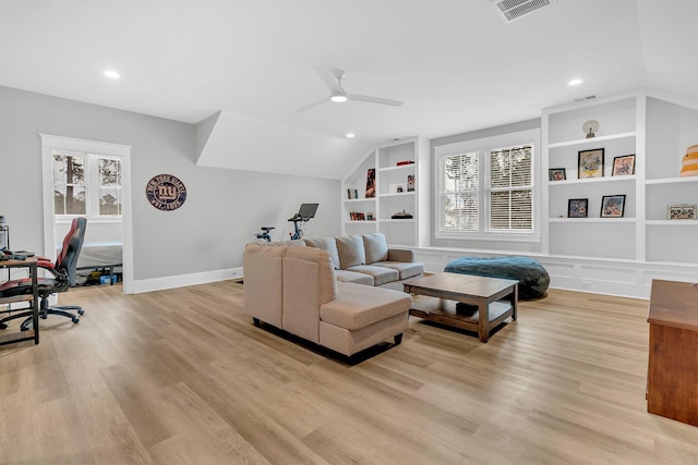 living room with vaulted ceiling, ceiling fan, light wood-type flooring, and built in features