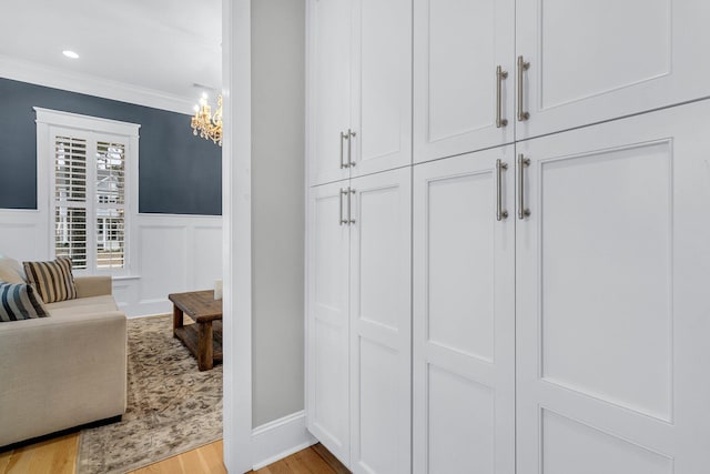 interior space with light wood-type flooring and crown molding