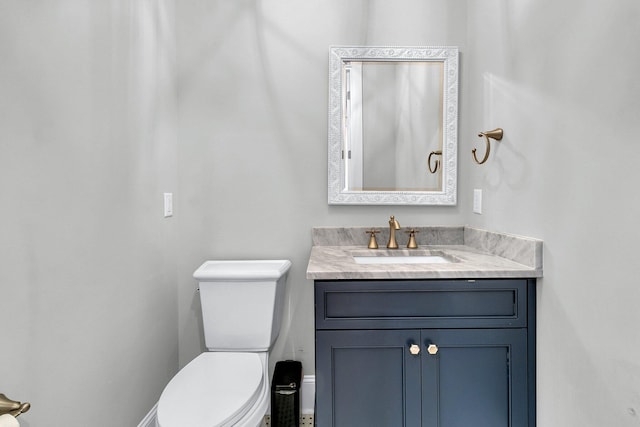 bathroom featuring toilet and vanity