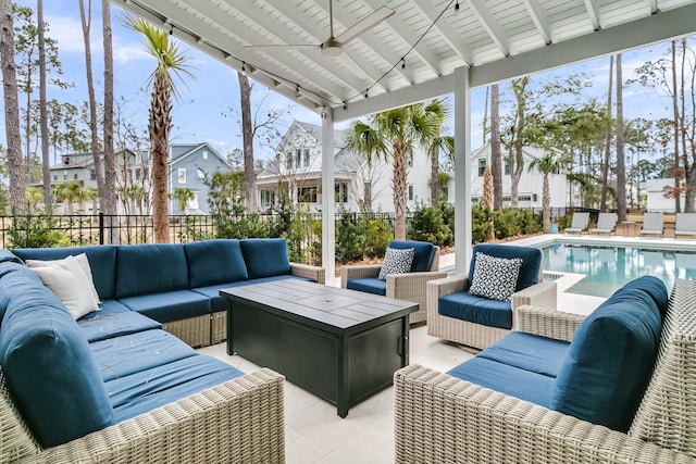 sunroom featuring a pool, beam ceiling, ceiling fan, and a wealth of natural light