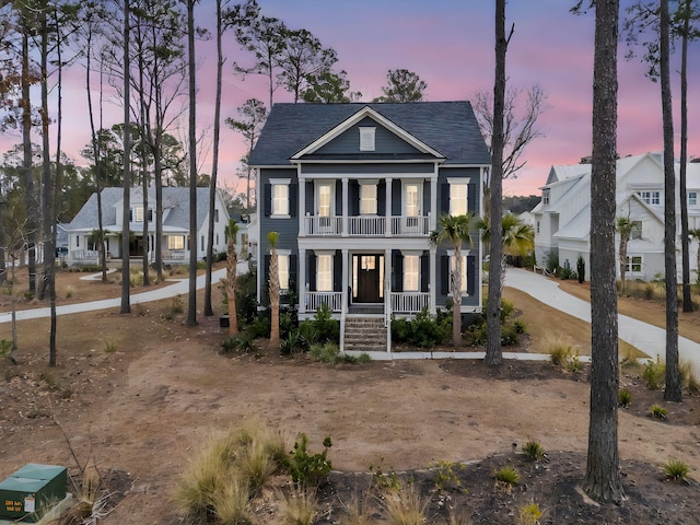 view of front of property featuring a balcony and covered porch