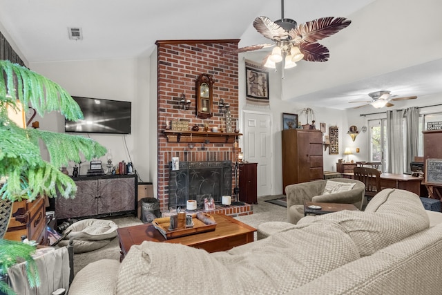 living area with carpet flooring, visible vents, a brick fireplace, lofted ceiling, and ceiling fan
