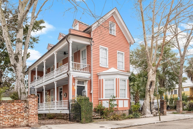 view of front of home with a balcony and ceiling fan