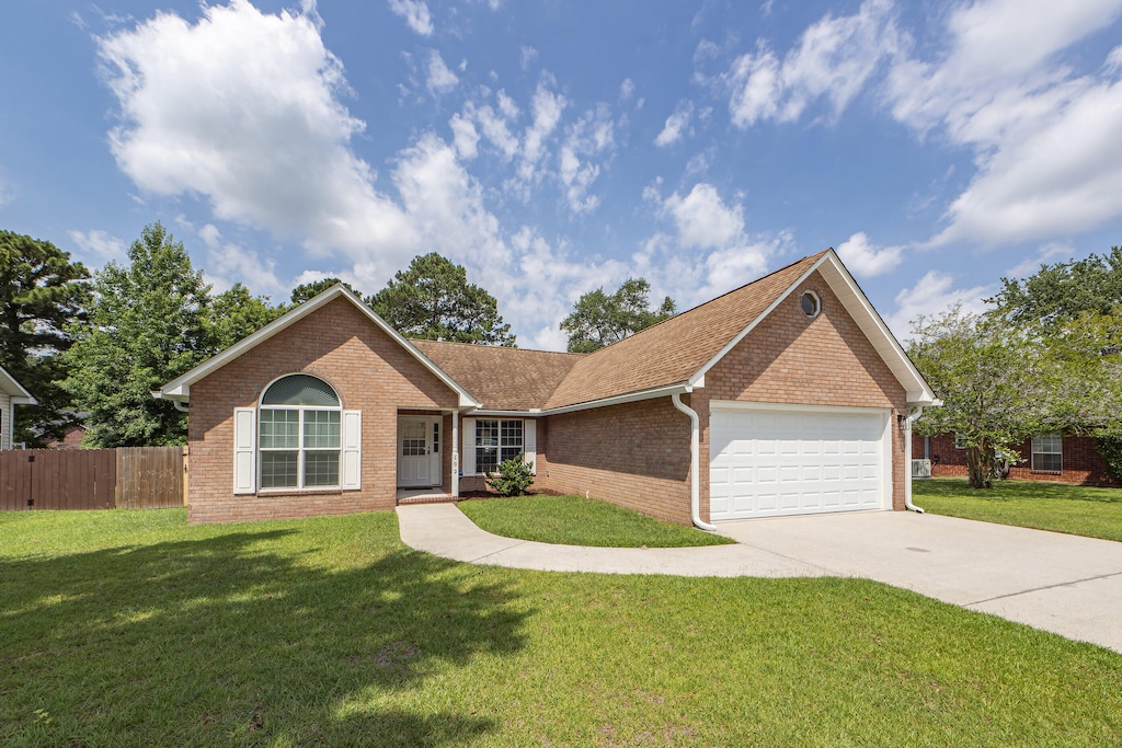 ranch-style house with a front yard and a garage