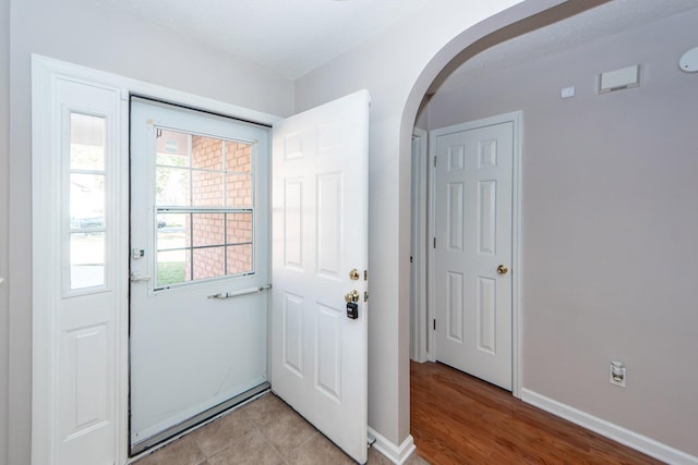 doorway to outside featuring light tile patterned flooring