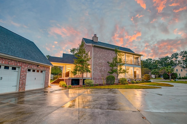 view of front of house with a garage and a balcony