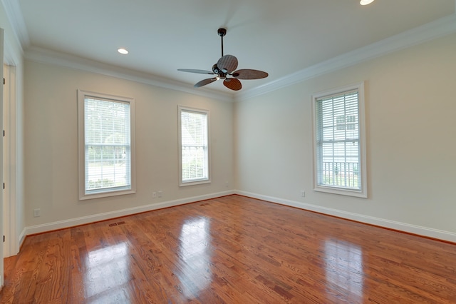 spare room with ceiling fan, ornamental molding, and light hardwood / wood-style flooring