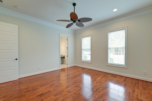 spare room with ornamental molding, light wood-type flooring, and ceiling fan