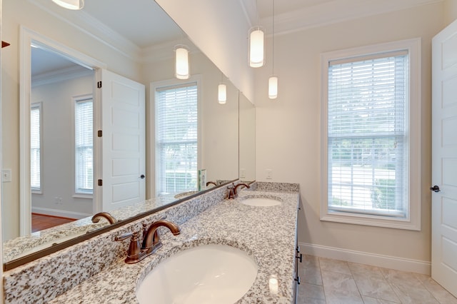 bathroom with vanity, a healthy amount of sunlight, tile patterned floors, and ornamental molding