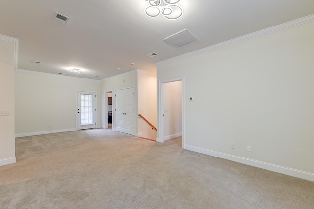 carpeted empty room featuring crown molding