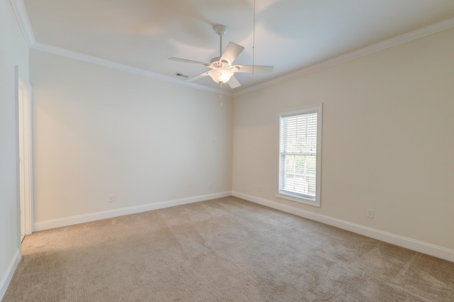 carpeted empty room featuring ceiling fan and crown molding