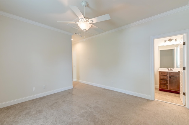 spare room featuring ceiling fan, light carpet, and ornamental molding