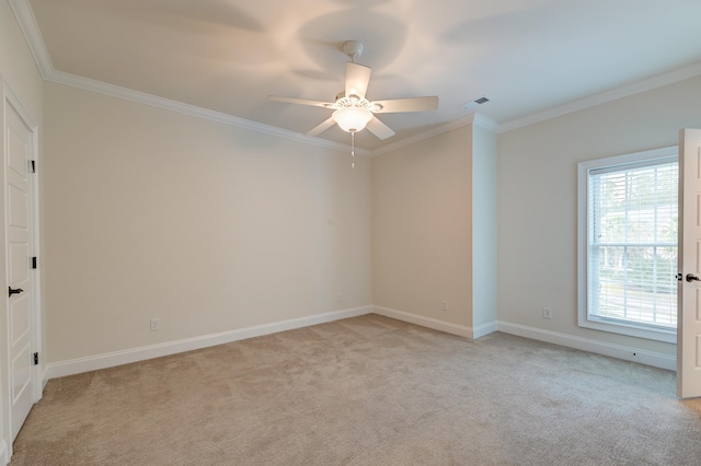 unfurnished room with ceiling fan, light colored carpet, and ornamental molding