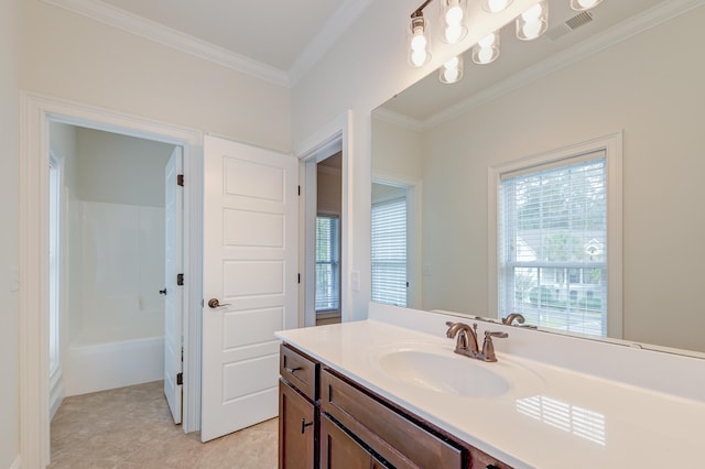 bathroom with vanity, tile patterned flooring, a healthy amount of sunlight, and crown molding