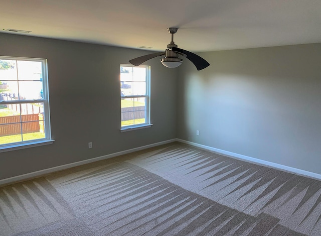 carpeted empty room with ceiling fan and vaulted ceiling