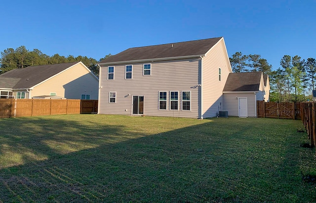 rear view of property with a yard and cooling unit