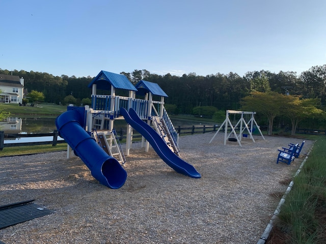 view of playground with a water view