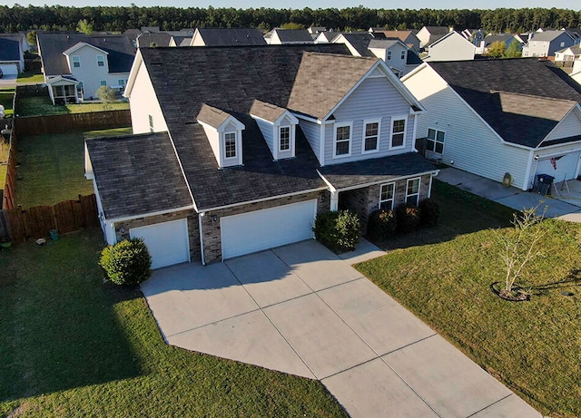 view of front of property featuring a garage and a front lawn