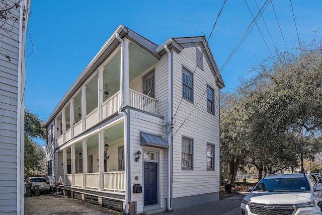 exterior space featuring covered porch and a balcony