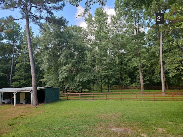 view of yard with an outdoor structure and a rural view