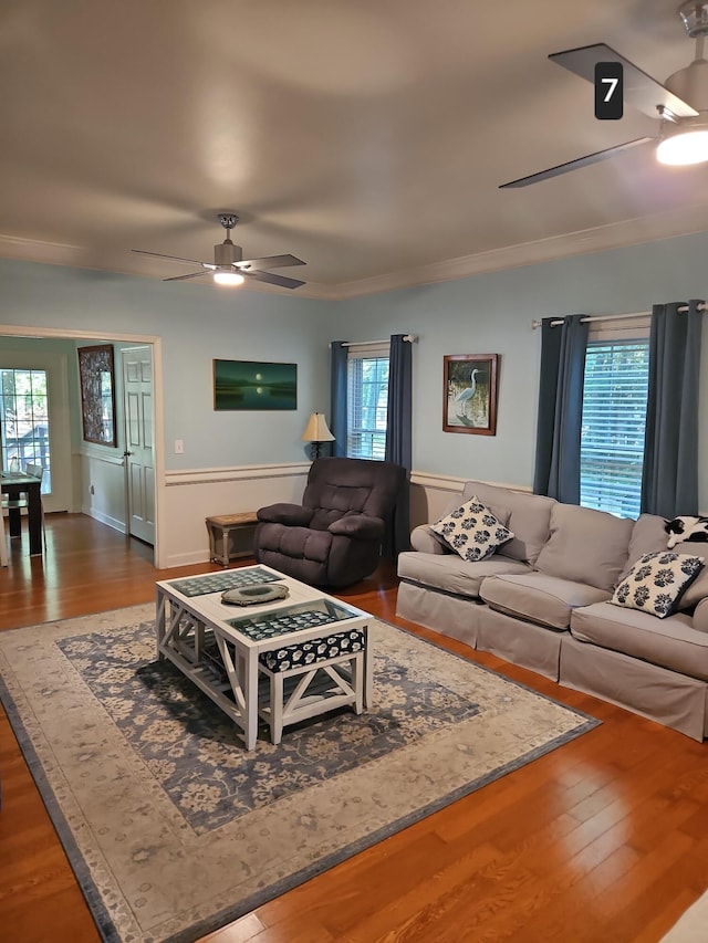 living room featuring ceiling fan, ornamental molding, hardwood / wood-style floors, and a wealth of natural light