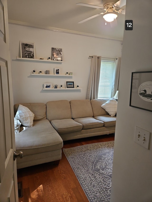 living room featuring ceiling fan, hardwood / wood-style flooring, and crown molding