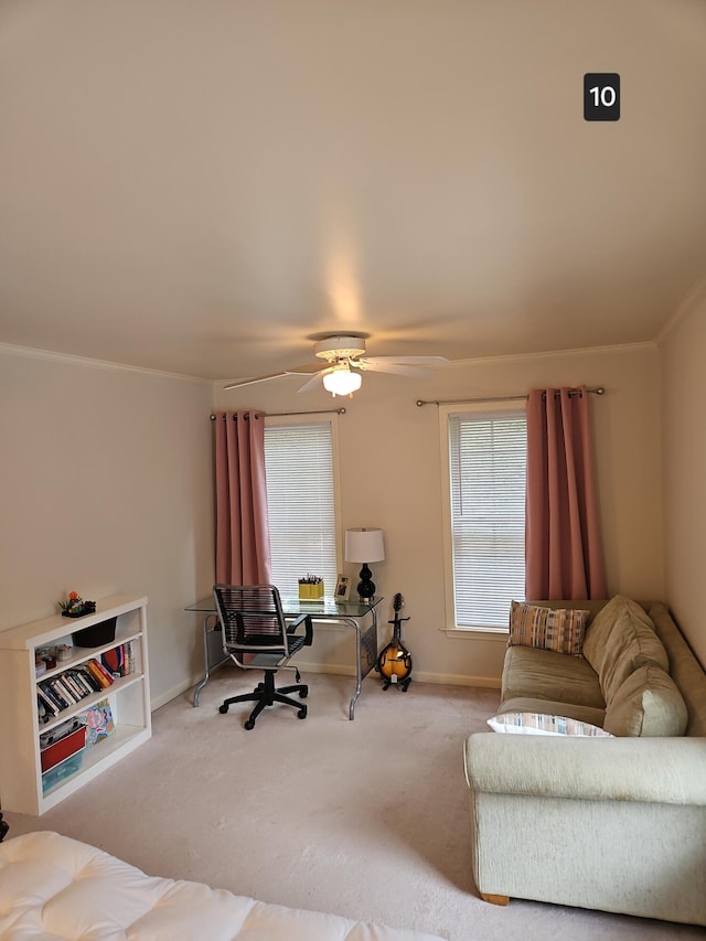 living room with ceiling fan, ornamental molding, and carpet